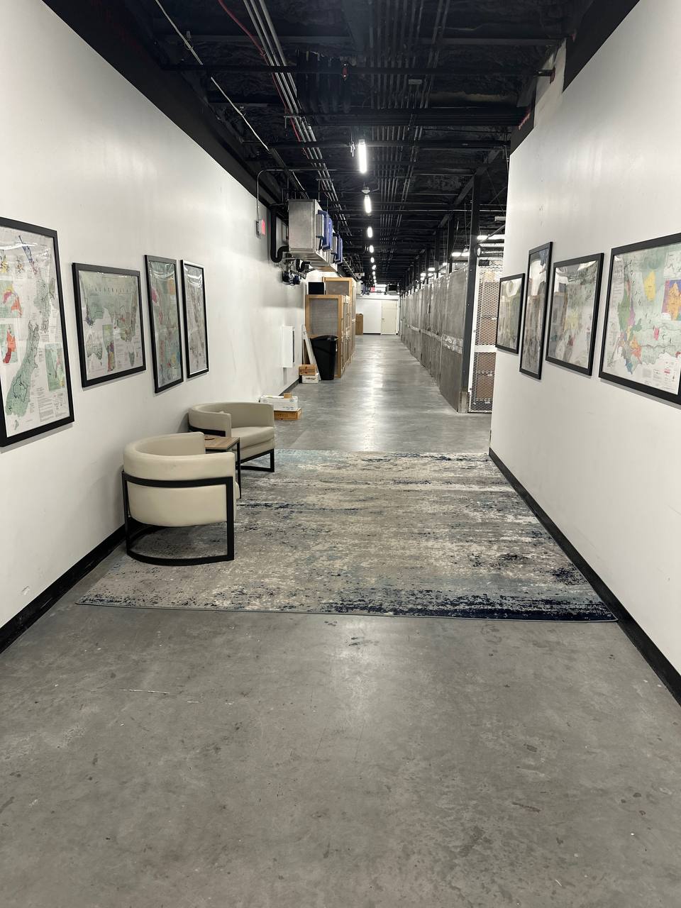 Carl's Wine Vault client corridor with wine-region maps